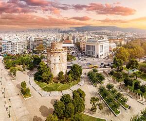 Blick auf die Küste von Thessaloniki, Griechenland, mit historischen Gebäuden und blauem Meer im Hintergrund.